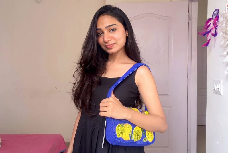 Woman styling a handcrafted boho shoulder bag with a flowy dress