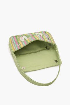 Green bag with colorful embroidered top on a white background