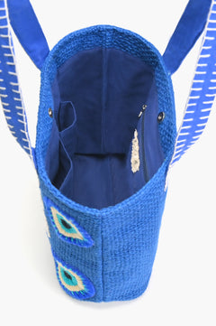 Inside of blue jute tote bag showing zip and mobile pockets