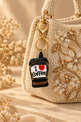 Black beaded I love coffee cup keychain with red heart on a stone tray