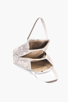 An open shoulder bag with a beige and white floral patterned exterior, a beige .
