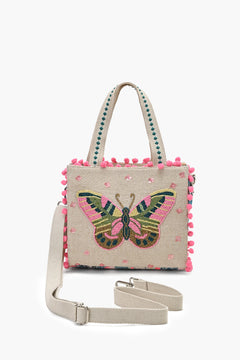 Handbag with butterfly design and pom-pom details on a white background