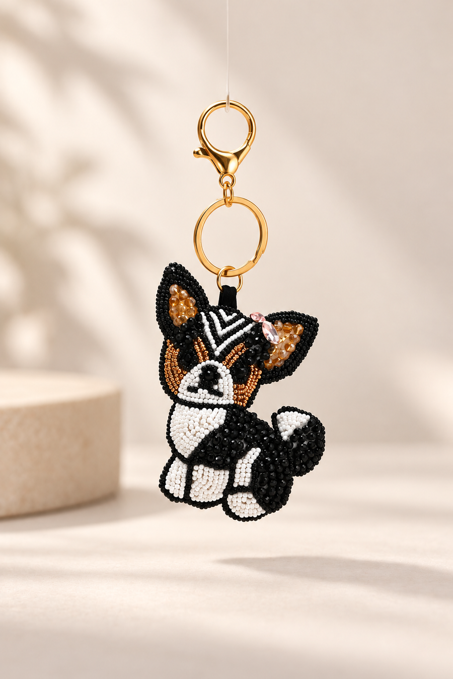 Milo black and white beaded dog keychain with tan ears and pink bow