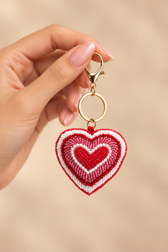 a red and white beaded heart keychain with a gold clasp 