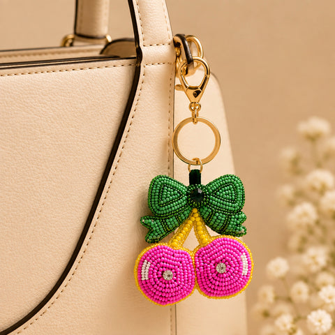 Pink beaded cherry keychain with green bow