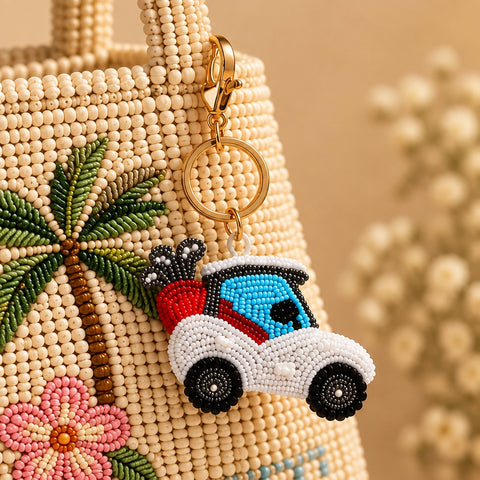 White and blue beaded golf cart keychain with red golf bag on a stone tray